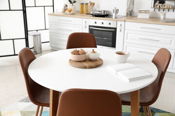 Dining table in interior of modern kitchen