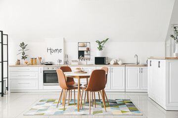 Interior of stylish modern kitchen with dining table - obrazy, fototapety, plakaty