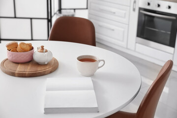 Fototapeta na wymiar Dining table in interior of modern kitchen