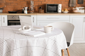 Dining table in interior of modern kitchen