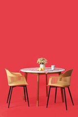 Dining table with chairs on color background