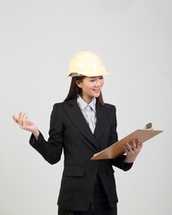 Young Asian female wearing suit safety helmet looking holding clipboard