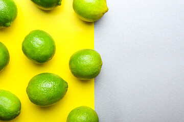 Fresh green limes on color background
