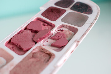 Decorative сosmetic set broken eyeshadow on white background. Macro photo beauty tool for eyes.