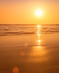 A colorful sunset or sunrise on the seaside with a sandy beach with impurities of volcanic ash. Mandrem, Goa, India.