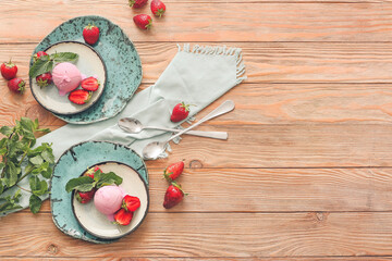 Tasty strawberry ice cream on table