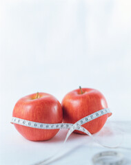 red apple with measuring tape, apple with measure inch tape 

