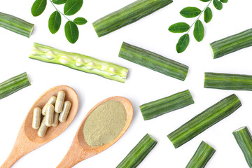 Moringa Oleifera and moringa powder capsule with green leaf isolated on white background. Top view. Flat lay.