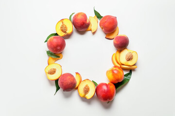Frame made of sweet ripe peaches on white background