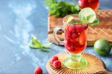Cup of cold raspberry tea on table