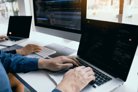 Two software developers are analyzing together about the code written into the program on the computer.