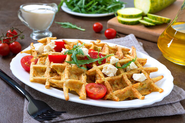Zucchini waffles with goat cheese, tomatoes, arugula. Proper nutrition. Healthly food.