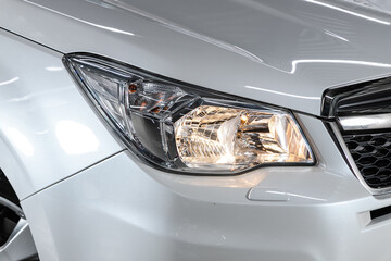 Detail light close up of on new silver  car. Exterior detail ..