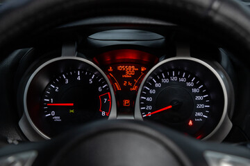 Car dashboard with white  backlight: Odometer, speedometer, tachometer, fuel level, water temperature and more.