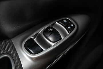 Obraz na płótnie Canvas Interior of modern car. Side door buttons: window, mirror adjustment buttons, door lock. Car inside..