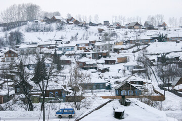 Spring in the Altai Mountains. Snow-covered mountain village. Altai Krai, Russia.