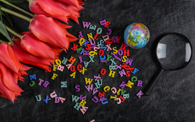 Bouquet of tulips and school supplies, letters on chalk board. Knowledge Day, back to school. Top...