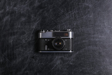 Retro film camera on chalk black board close-up. Top view