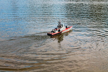 Toy battle ship floats in water. Children battle ship toy modern model sailing in lake, river....