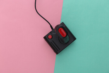Retro joystick on pink blue pastel background. Gaming, video game competition