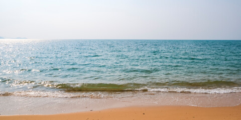 Caribbean beach with golden sand, emerald water and blue sky with clouds. Empty beach. Copy space banner.