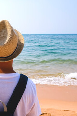 Summer holidays, travel, tourism and vacation concept. Boy in a hat on a beach or near the swimming pool. Banner.