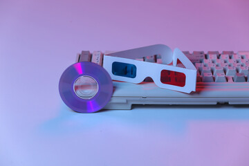 CD with, 3d glasses, old pc keyboard. Pink blue gradient neon, holographic light. Retro wave....