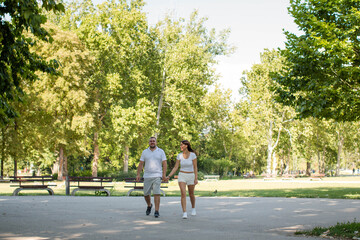 Fototapeta premium young couple walking in the park