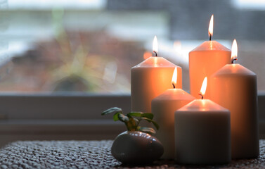 burning candles on a wooden table