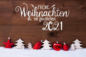 Fototapeta na wymiar German Calligraphy Frohe Weihnachten Und Ein Glueckliches 2021 Means Merry Christmas And A Happy 2021. Red Christmas Decoration Like Tree And Ball Ornament. Wooden Background With Snow