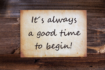 Obraz premium Old Grungy Paper With English Quote It Is Always A Good Time To Begin. Wooden Background