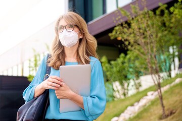 Mature woman wearing face mask on the street while going to work