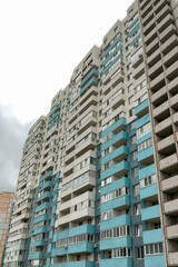 Typical high rise apartment building with balcony and windows. Contemporary architecture. Selective focus. Close-up.
