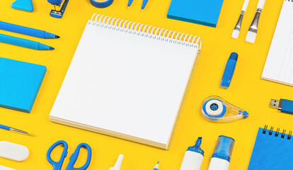 Assorted office and school white and blue stationery on bright yellow background. Organized knolling for back to school or education and craft concept. Selective focus. Banner. Copy space. Mockup