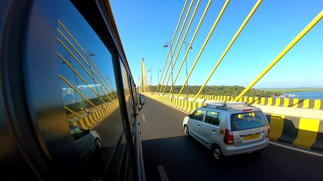 Side view of car passing the Atal Setu cable bridge in India