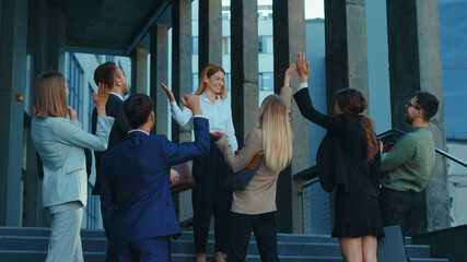 Teambuilding. Motivational blonde businesswoman leader saying good news for her staff. Euphoric...