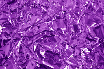 Purple metallic foil shiny texture, wrinkled wrapping paper for background and design art work.