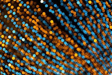Bokeh from a small blue and gold light on a Christmas tree