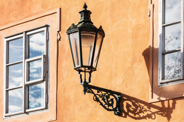 Fototapeta na wymiar old street lamp on yellow wall