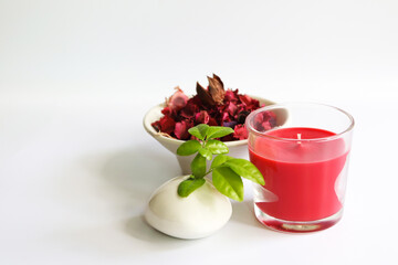 red candle and Dried flower petals