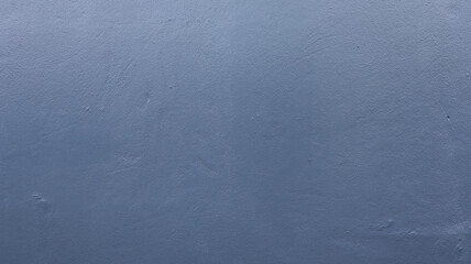 The background of the blue grunge wall is uneven and the angle of shooting is close up outside the building.