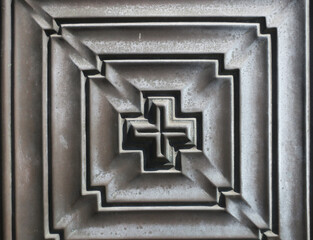 cross pattern on an iron door of a building in Amsterdam