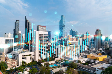 Obraz premium Forex and stock market chart hologram over panorama city view of Bangkok, the financial center in Asia. The concept of international trading. Double exposure.