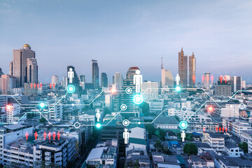 Obraz premium Hologram of social media icons over sunset panoramic cityscape of Bangkok, Asia. The concept of people connections. Multi exposure.
