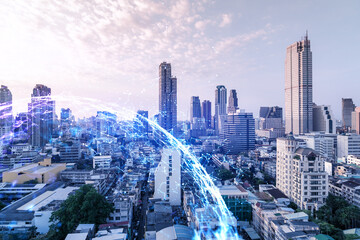 Fototapeta premium Hologram of abstract technology glowing icons, panoramic cityscape of Bangkok at sunset, Asia. The concept of worlds technological changes. Double exposure.