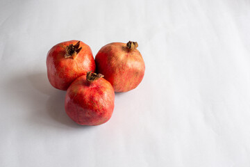 Fresh whole ripe pomegranates isolated on white background