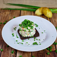 Homemade salad with potatoes on a white plate