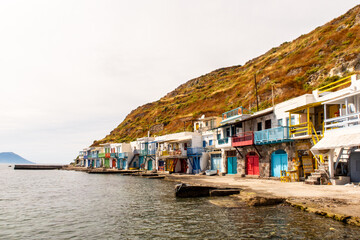 Klima fishermen village on Milos Island - the most colorful fishing village in Greece, with colorful doors, window shutters and balconies and traditional whitewashed walls, landscape view on sunny day