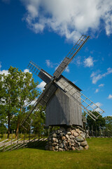 Plakat old wooden wind-mill on a colorful summer day