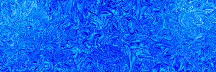 Abstract textured background banner of blue liquid paint swirls